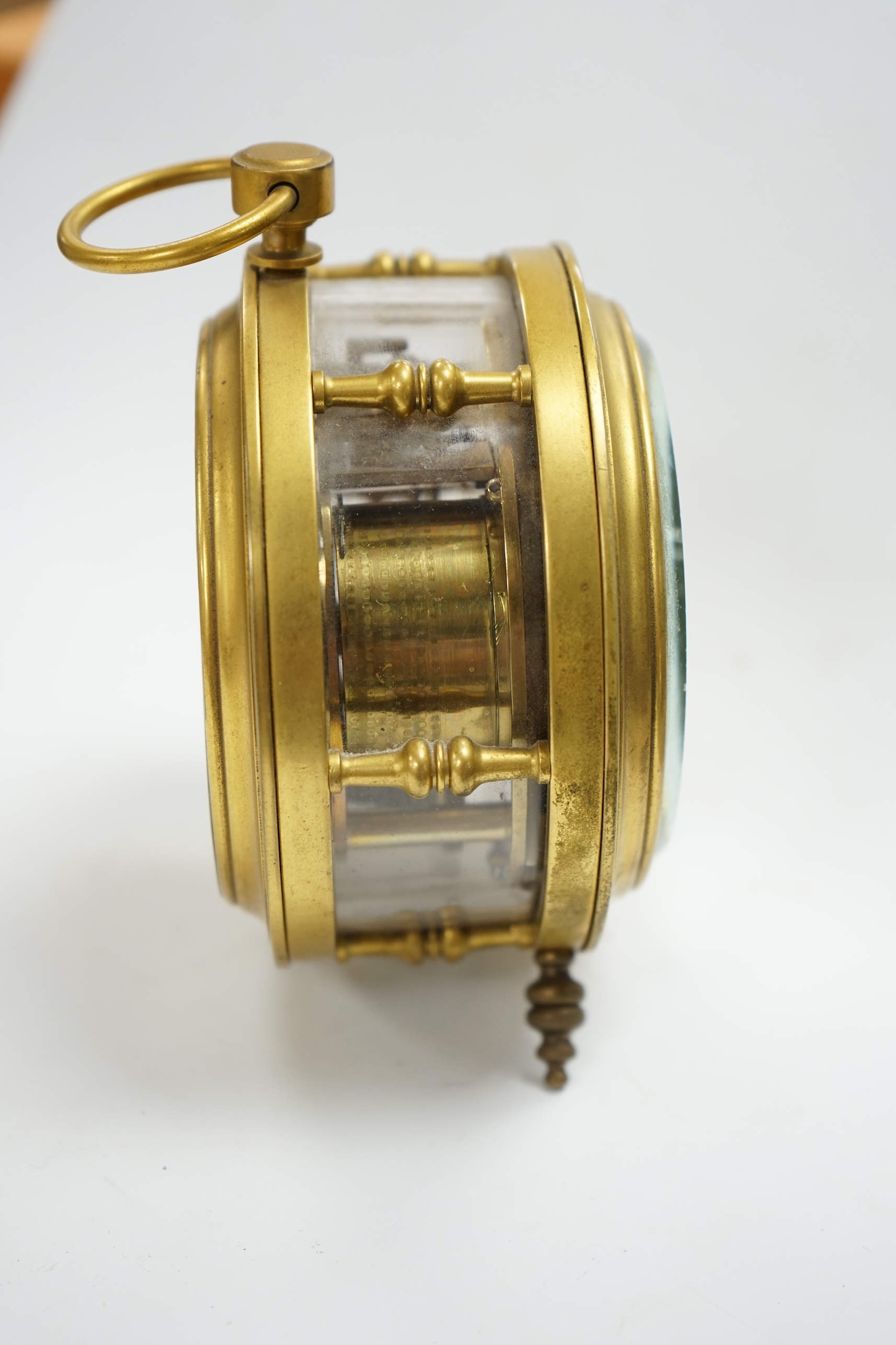 A late 19th century brass and glass drum shaped timepiece unusually with an English single fusee movement with platform lever escapement, 12.5cm high. Condition - good, unchecked if in working order